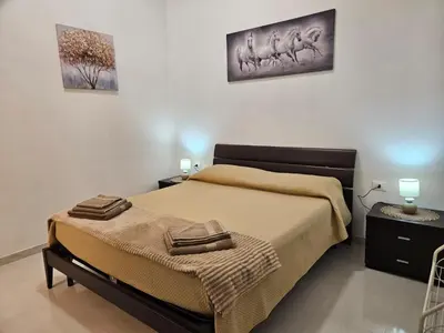 a bedroom with a bed with two towels on it at Casa Lumìa in Palermo