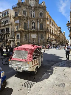 an old car is parked in front of a building at Casa Lumìa in Palermo