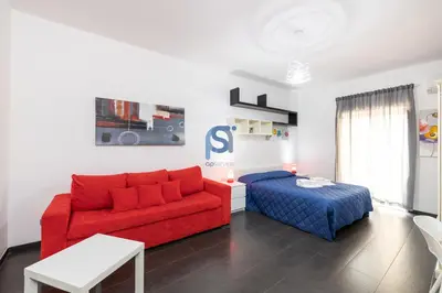 a living room with a couch and a bed at Il Vittoria - Self Check in in Lascari