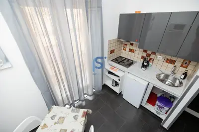 a small kitchen with a sink and a stove at Il Vittoria - Self Check in in Lascari