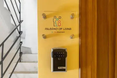 a yellow door with a sign that reads palagon of living is an elevator at Palermo of living appartamento Centro Storico in Palermo