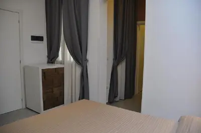 a bedroom with a bed and curtains in a room at B&B Il Sole in Castelluzzo