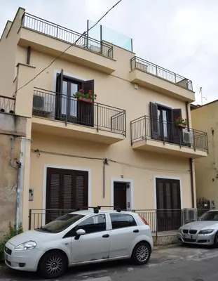 a white car parked in front of a building at Casa Penelope in Mondello