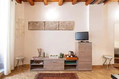 a living room with a wooden cabinet and a tv at GuestHost - GuestHost - Giusino Experience in Palermo's Heart in Palermo