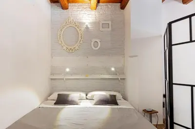 a bedroom with a bed and a mirror on the wall at GuestHost - GuestHost - Giusino Experience in Palermo's Heart in Palermo