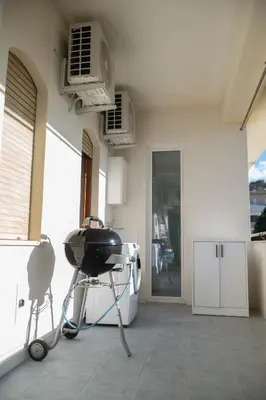 a kitchen with a grill on a patio at La perla sulla spiaggia in Alcamo Marina