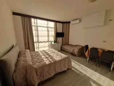 a bedroom with a bed and a large window at Claudio House Palermo in Palermo