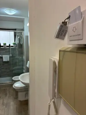 a bathroom with a urinal and a toilet and a sink at Claudio House Palermo in Palermo