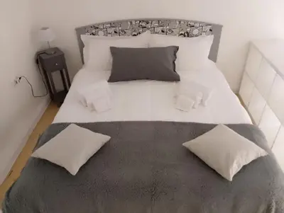 a bedroom with a large white bed with two pillows at Appartamento centro storico(Nina's house stazione) in Palermo