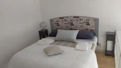 a white bed with two pillows on top of it at Appartamento centro storico(Nina's house stazione) in Palermo