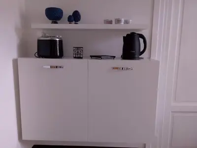 a white refrigerator with two appliances on top of it at Appartamento centro storico(Nina's house stazione) in Palermo