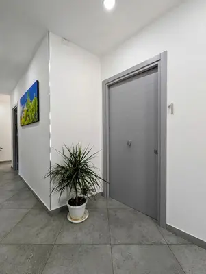 a door in a room with a potted plant at I colori della Sicilia in Cinisi
