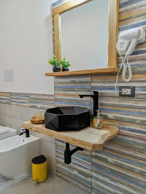 a bathroom with a sink and a mirror at I colori della Sicilia in Cinisi