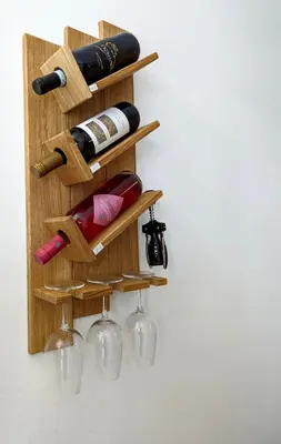 a wooden wine rack with wine bottles and wine glasses at I colori della Sicilia in Cinisi
