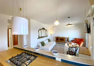 a kitchen and living room with a couch and a table at Solemar Sicilia - Casa Tosca in Ficarazzi