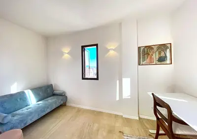 a living room with a blue couch and a table at Solemar Sicilia - Casa Tosca in Ficarazzi