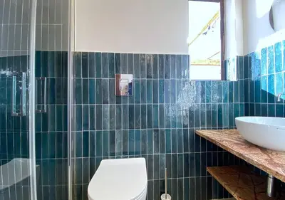 a bathroom with a toilet and a sink at Solemar Sicilia - Casa Tosca in Ficarazzi