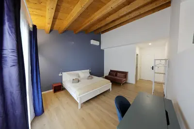 a bedroom with a bed and a couch and a table at Argenteria5 Holiday Rooms in Palermo