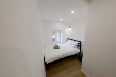 a white bedroom with a bed with white sheets at Argenteria5 Holiday Rooms in Palermo