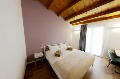 a bedroom with a white bed and a window at Argenteria5 Holiday Rooms in Palermo