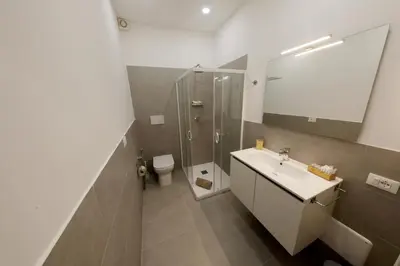 a bathroom with a sink and a shower and a toilet at Argenteria5 Holiday Rooms in Palermo