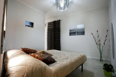 a bedroom with a bed with pillows on it at Casa Le Nereidi in Castellammare del Golfo