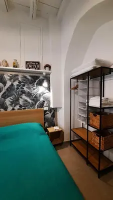 a room with a bed and a shelf with towels at Holiday Home Celsus 84 in Palermo