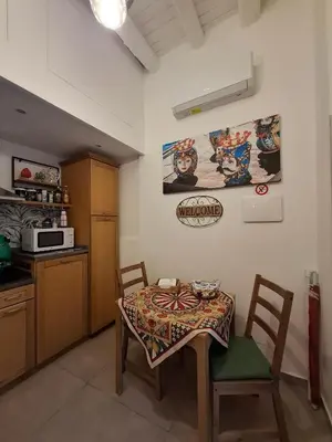 a kitchen with a table and chairs and a microwave at Holiday Home Celsus 84 in Palermo