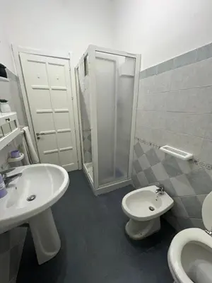 a bathroom with a sink and a toilet and a shower at L' Arco Antico in Palermo