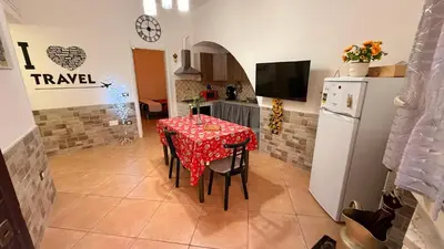 a kitchen with a table with a red table cloth at L' Arco Antico in Palermo