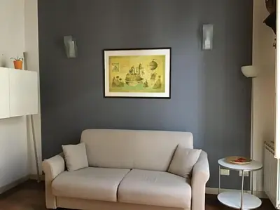 a living room with a couch and a picture on the wall at Appartamento Alessandro al porto in Palermo