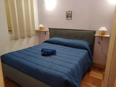 a blue teddy bear laying on a blue bed at Appartamento Alessandro al porto in Palermo
