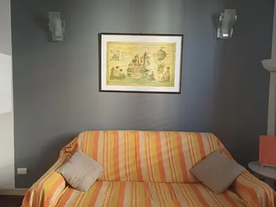 a bed in a room with a picture on the wall at Appartamento Alessandro al porto in Palermo