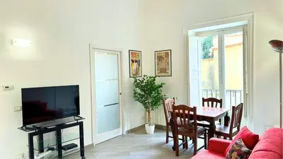 a living room with a couch and a table with a tv at Residenza Cattedrale in Palermo