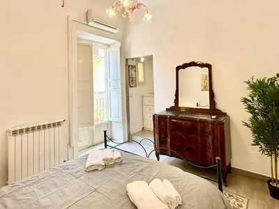 a bedroom with a bed and a mirror and a dresser at Residenza Cattedrale in Palermo