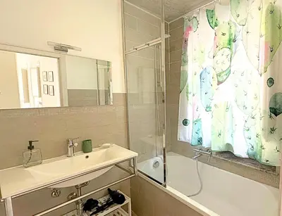 a bathroom with a sink and a shower curtain at Residenza Cattedrale in Palermo