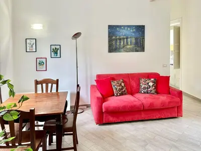 a living room with a red couch and a table at Residenza Cattedrale in Palermo