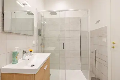 a bathroom with a sink and a glass shower at Lascaris 11 in Palermo