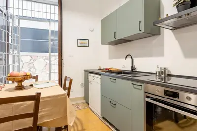 a kitchen with a table with a bowl of fruit on it at Cicco's Home - Holidays Apartment in Palermo