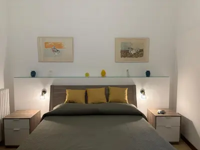 a room with a balcony with a bed and a table at Cicco's Home - Holidays Apartment in Palermo