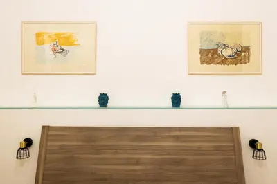 a living room with two framed pictures on the wall at Cicco's Home - Holidays Apartment in Palermo