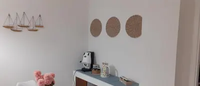 a room with a white wall with a table and some mirrors at Reef Mondello Apartment in Palermo