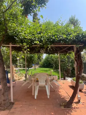 a table and chairs under a pergola in a park at La Villetta di Sofia in Carini