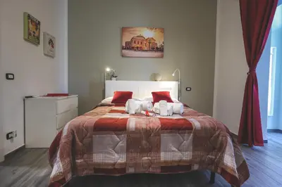 a bedroom with a bed with two stuffed animals on it at Il Bel Canto - Suite in centro storico in Palermo