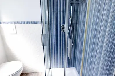 a bathroom with a glass shower with a toilet at Il Bel Canto - Suite in centro storico in Palermo