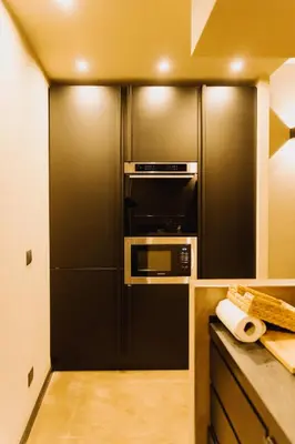 a kitchen with a black refrigerator and a microwave at QUIETE e MARE in San Vito lo Capo