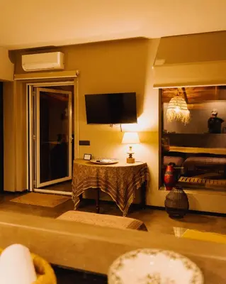 a living room with a television and a table at QUIETE e MARE in San Vito lo Capo