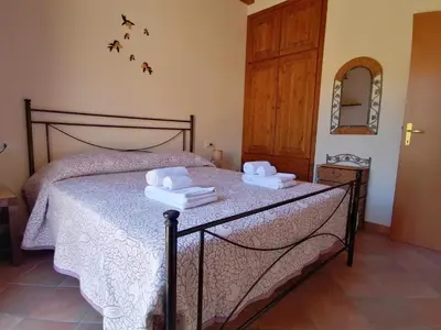 a bedroom with a bed with two towels on it at Villa Francesca in Castelluzzo