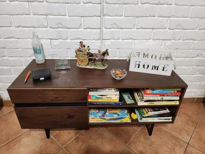 a wooden table with a book shelf with books at Maison M&M in Palermo
