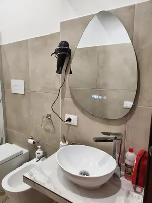 a bathroom with a sink and a mirror on the wall at Maison M&M in Palermo
